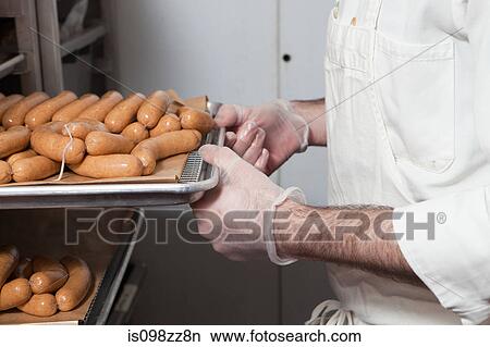 Butcher with tray of sausages View Large Photo Image Picture - Butcher with tray of sausages. Fotosearch