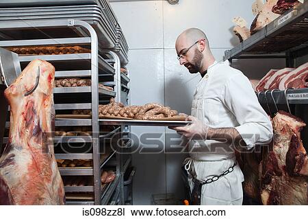 Butcher with tray of sausages View Large Photo Image Stock Image - Butcher with tray of sausages. Fotosearch