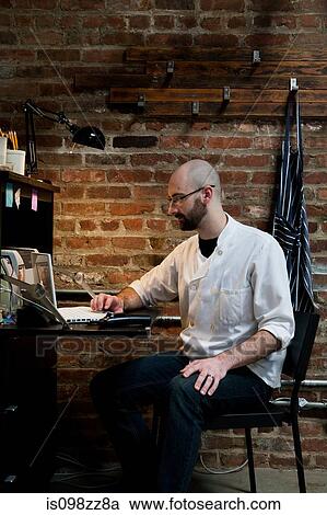 Butcher working on laptop View Large Photo Image Stock Image - Butcher working on laptop. Fotosearch