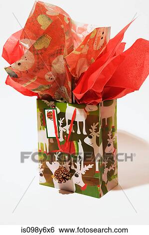 Christmas gift bag against white background View Large Photo Image Stock Photograph - Christmas gift bag against white background. Fotosearch