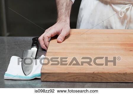 Close up of butcher with chopping board and knife View Large Photo Image Stock Image - Close up of butcher with chopping board and knife. Fotosearch