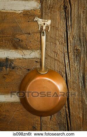Copper pan hanging up View Large Photo Image Stock Photograph - Copper pan hanging up. Fotosearch