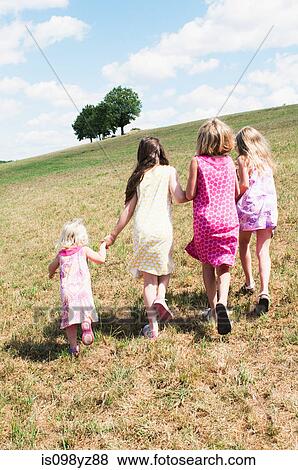 Four girls walking in field View Large Photo Image Stock Photo - Four girls walking in field. Fotosearch
