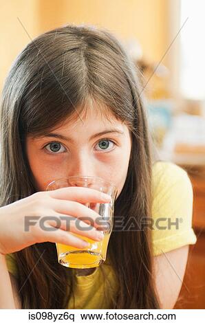 Girl Drinking Orange Juice Stock Photography Is098yz6q Fotosearch