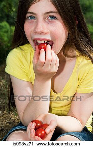 Girl eating cherry tomatoes View Large Photo Image Stock Image - Girl eating cherry tomatoes. Fotosearch