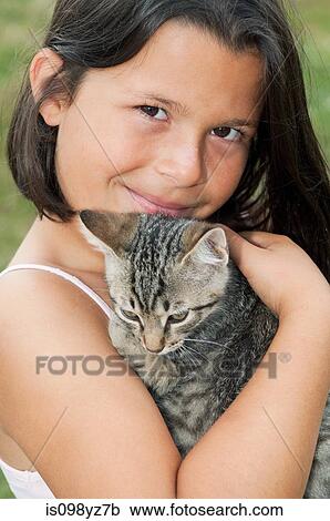 Girl holding pet cat, portrait View Large Photo Image Stock Image - Girl holding pet cat, portrait. Fotosearch
