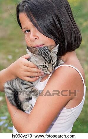 Stock Photo - Girl holding pet cat, portrait. Fotosearch