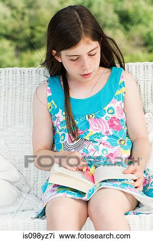 Stock Image - Girl reading book. Fotosearch