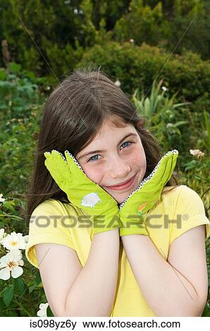 Girl wearing gardening gloves, portrait View Large Photo Image Stock Photo - Girl wearing gardening gloves, portrait. Fotosearch