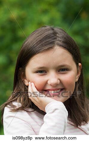 Stock Photography - Girl with hand on chin, portrait. Fotosearch