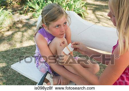 Girl with injured knee View Large Photo Image Stock Image - Girl with injured knee. Fotosearch