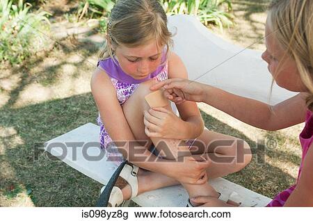Girl with injured knee View Large Photo Image Stock Image - Girl with injured knee. Fotosearch