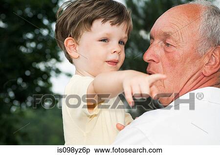 Stock Photography - Grandfather and grandson, boy pointing. Fotosearch
