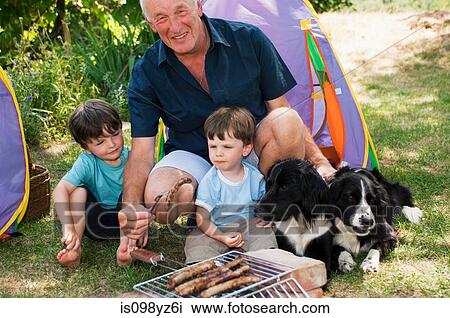 Grandfather and grandsons having barbecue View Large Photo Image Stock Image - Grandfather and grandsons having barbecue. Fotosearch