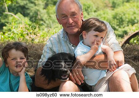 Grandfather with two grandsons and dog, portrait View Large Photo Image Stock Image - Grandfather with two grandsons and dog, portrait. Fotosearch