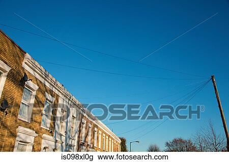 Stock Image - House exteriors against blue sky. Fotosearch