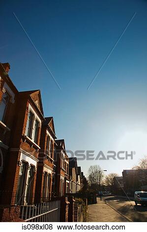 Stock Photo - House exteriors against blue sky. Fotosearch