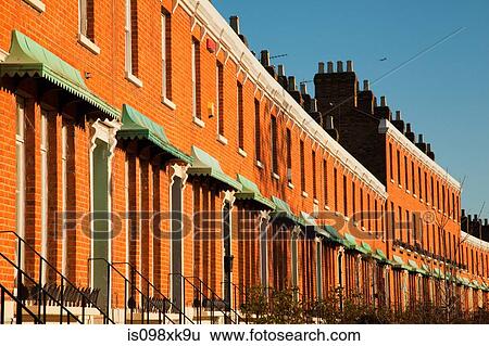 Stock Photograph - House exteriors against blue sky. Fotosearch