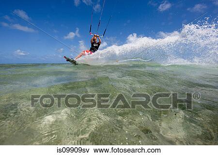 Kiteboarding in shallow water View Large Photo Image Stock Photo - Kiteboarding in shallow water. Fotosearch