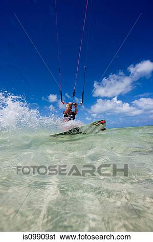 Kiteboarding in shallow water View Large Photo Image Stock Photograph - Kiteboarding in shallow water. Fotosearch