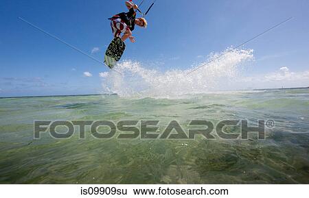 Kiteboarding in shallow water View Large Photo Image Stock Photograph - Kiteboarding in shallow water. Fotosearch
