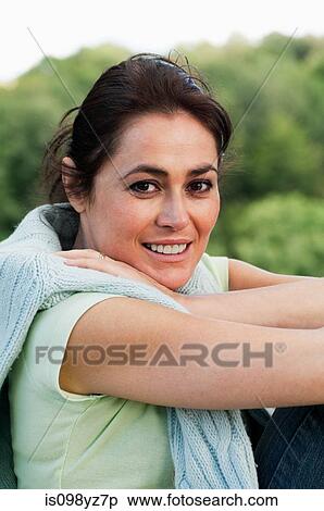 Stock Photography - Mid adult woman looking at camera, portrait. Fotosearch