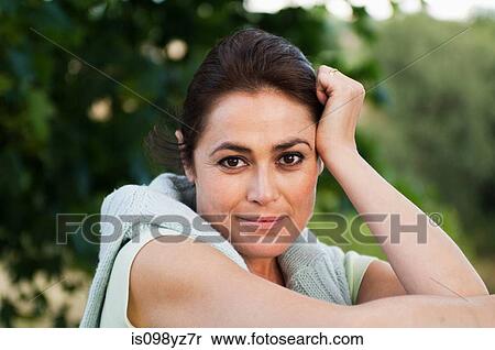Mid adult woman looking at camera, portrait View Large Photo Image Stock Photography - Mid adult woman looking at camera, portrait. Fotosearch