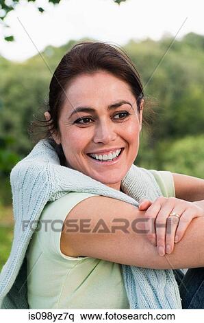 Stock Photography - Mid adult woman looking away, portrait. Fotosearch