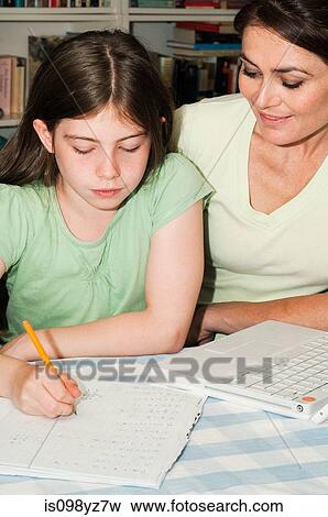 Mother helping daughter with homework View Large Photo Image Stock Photo - Mother helping daughter with homework. Fotosearch