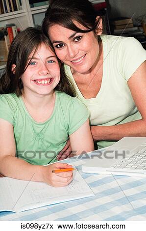Mother helping daughter with homework View Large Photo Image Stock Photo - Mother helping daughter with homework. Fotosearch