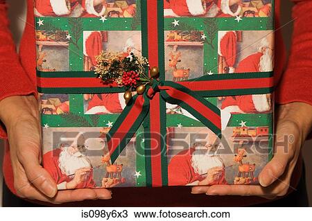 Person holding a christmas present View Large Photo Image Stock Image - Person holding a christmas present. Fotosearch