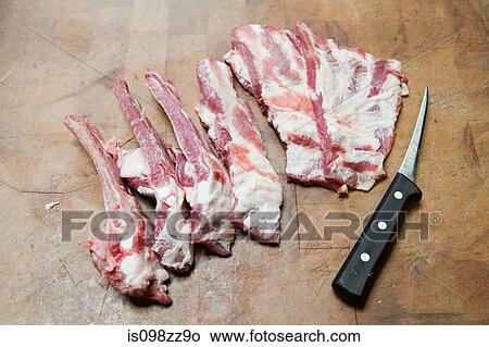 Picture - Pork ribs and knife. Fotosearch