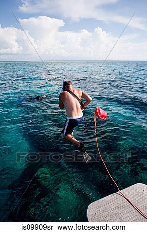 Stock Photography - Rescue of diver by boat crew. Fotosearch