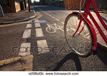 Stock Image - Road with cycle path and bicycle. Fotosearch