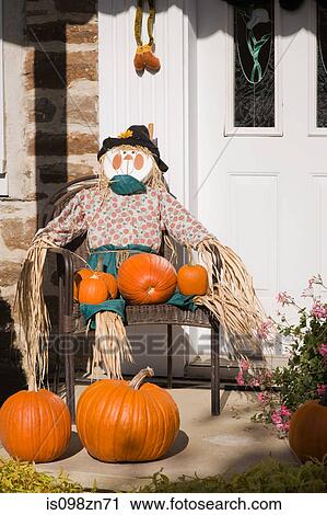 Scarecrow and pumpkins outside house View Large Photo Image Stock Image - Scarecrow and pumpkins outside house. Fotosearch