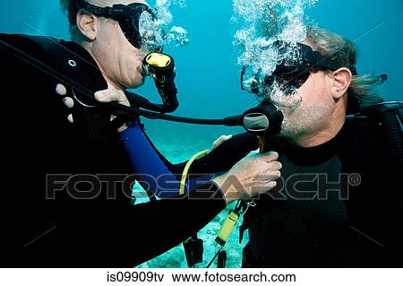 Scuba divers share air View Large Photo Image Stock Photo - Scuba divers share air. Fotosearch