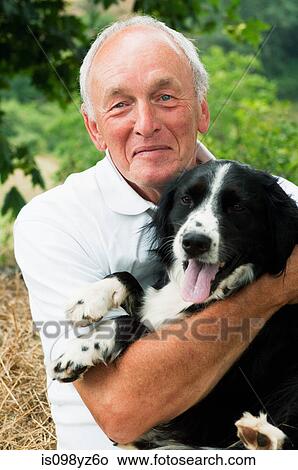 Senior man holding dog, portrait View Large Photo Image Picture - Senior man holding dog, portrait. Fotosearch