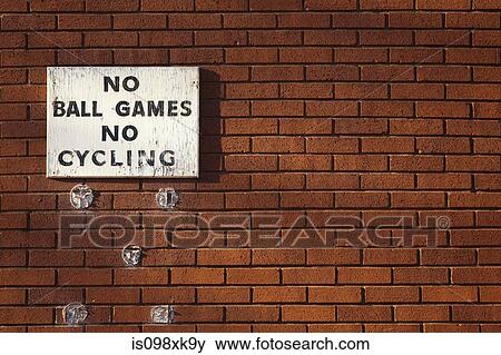 Sign on brick wall saying no ball games no cycling View Large Photo Image Stock Photo - Sign on brick wall saying no ball games no cycling. Fotosearch