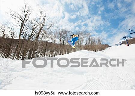 Snowboarder jumping in midair View Large Photo Image Stock Photograph - Snowboarder jumping in midair. Fotosearch