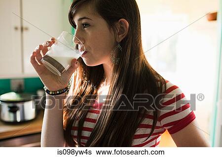 Teenage girl drinking glass of milk View Large Photo Image Stock Photograph - Teenage girl drinking glass of milk. Fotosearch