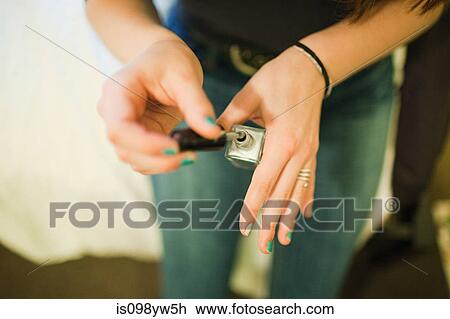 Teenage girl painting fingernails with nail varnish View Large Photo Image Stock Image - Teenage girl painting fingernails with nail varnish. Fotosearch