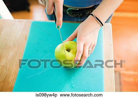 Teenage girl slicing apple View Large Photo Image Stock Photography - Teenage girl slicing apple. Fotosearch