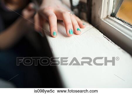Teenage girl with hand on windowsill wearing nail varnish View Large Photo Image Stock Image - Teenage girl with hand on windowsill wearing nail varnish. Fotosearch