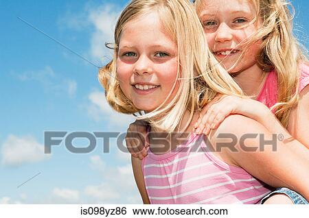 Stock Photograph - Two blonde haired girls, close up. Fotosearch