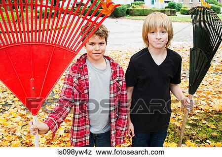 Two boys holding rakes View Large Photo Image Stock Photo - Two boys holding rakes. Fotosearch