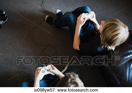 Two boys playing video games View Large Photo Image Stock Photo - Two boys playing video games. Fotosearch