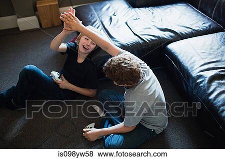 Two boys playing video games View Large Photo Image Stock Photo - Two boys playing video games. Fotosearch