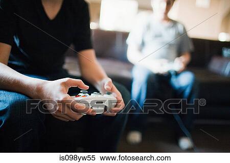Two boys playing video games View Large Photo Image Stock Photography - Two boys playing video games. Fotosearch