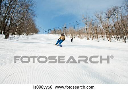 Two people snowboarding View Large Photo Image Stock Photo - Two people snowboarding. Fotosearch