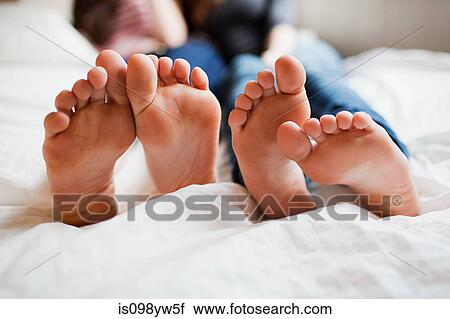Two teenage girls lying on bed barefoot View Large Photo Image Stock Image - Two teenage girls lying on bed barefoot. Fotosearch